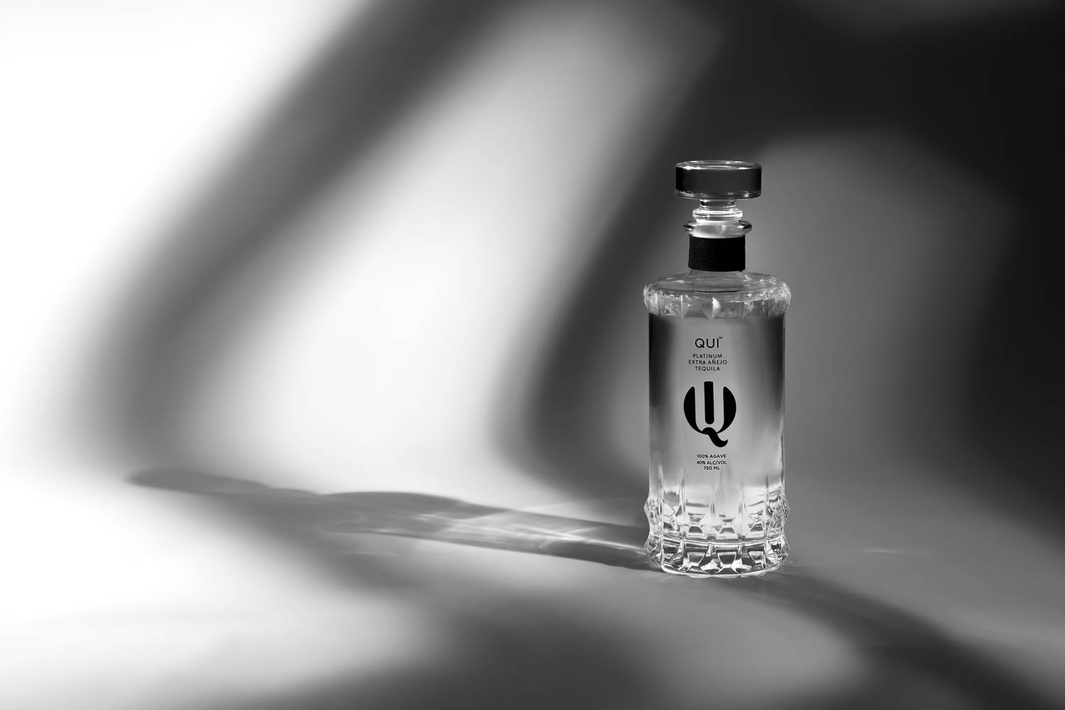 Tequila bottle product photography with dramatic shadow