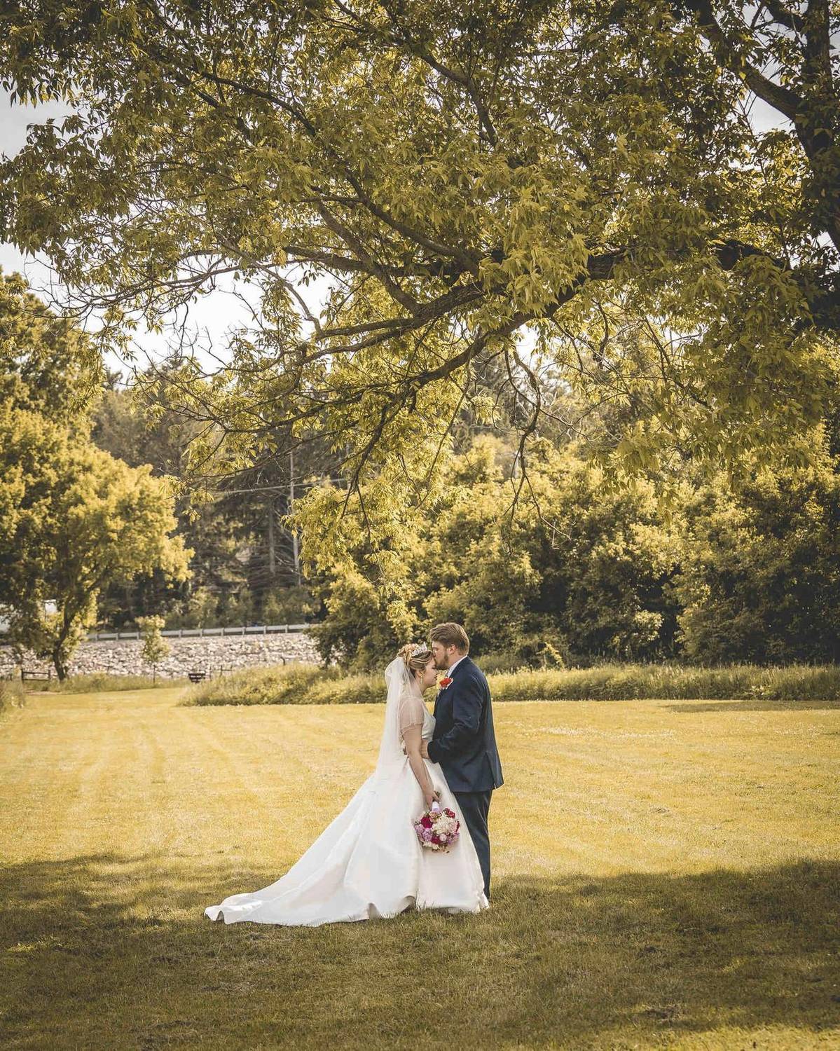 Bride and groom portrait under a tree