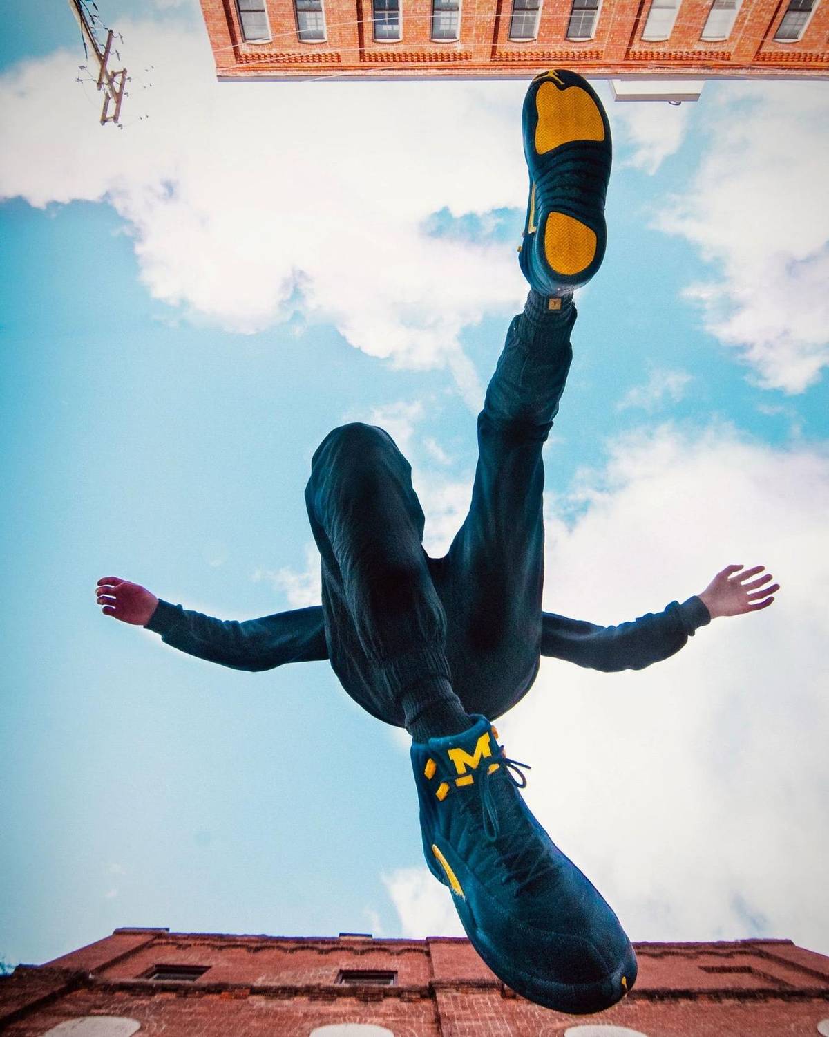 Freerunner captured mid-flip against a blue sky