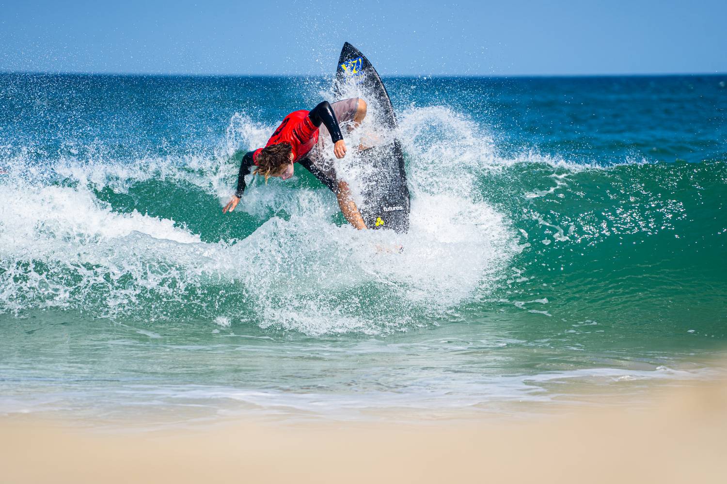 Surfer carving a sharp cutback on a breaking wave