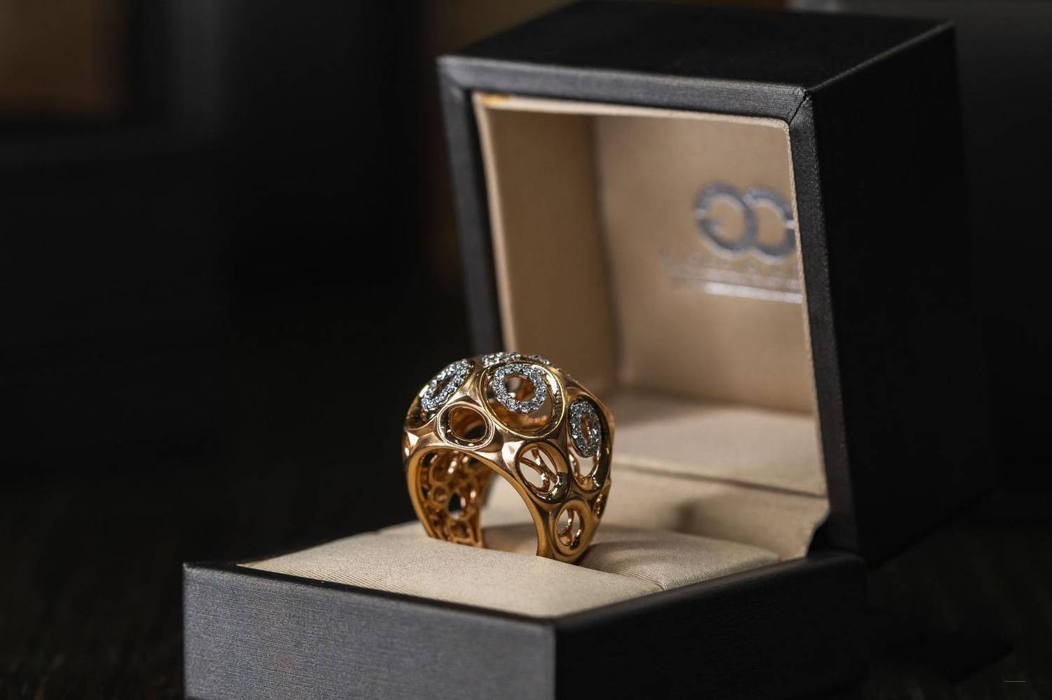 Gold diamond ring displayed in an open jewelry box