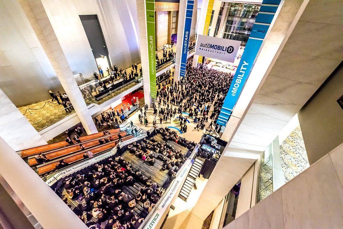 Aerial view of a crowd gathered at an auto show unveiling