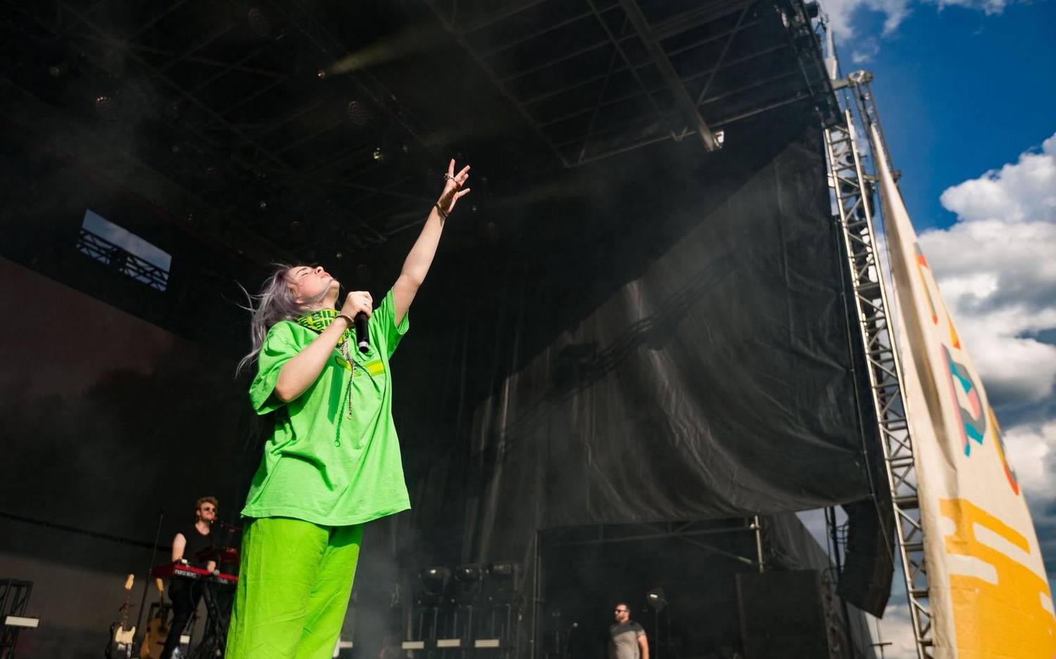 Musician performing on an outdoor festival stage