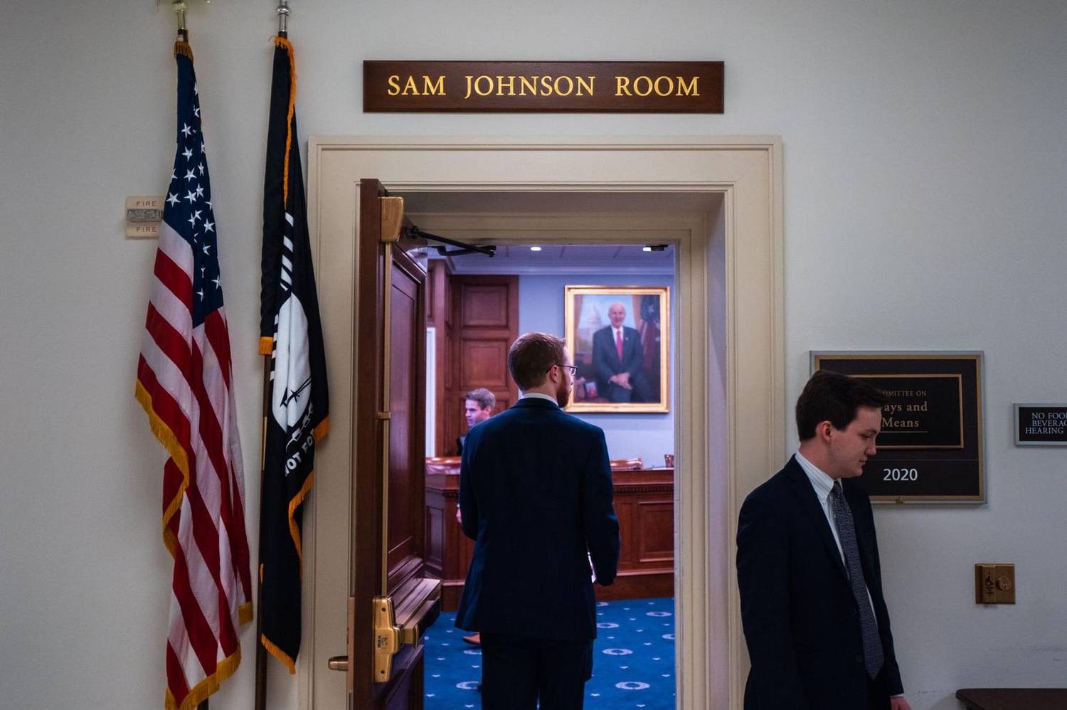 Staffers walking through a U.S. Capitol hallway outside a committee hearing room
