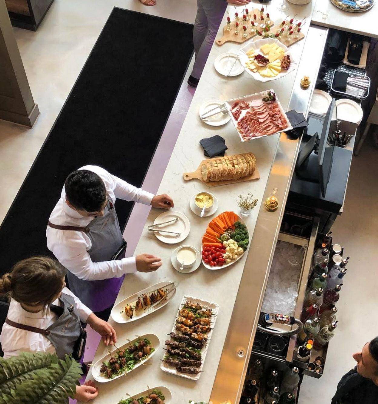 Overhead view of a catering spread being plated at an event
