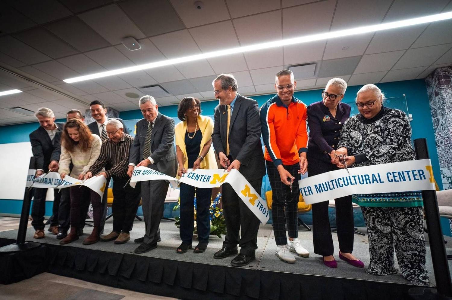 Group ribbon-cutting ceremony at a multicultural center opening
