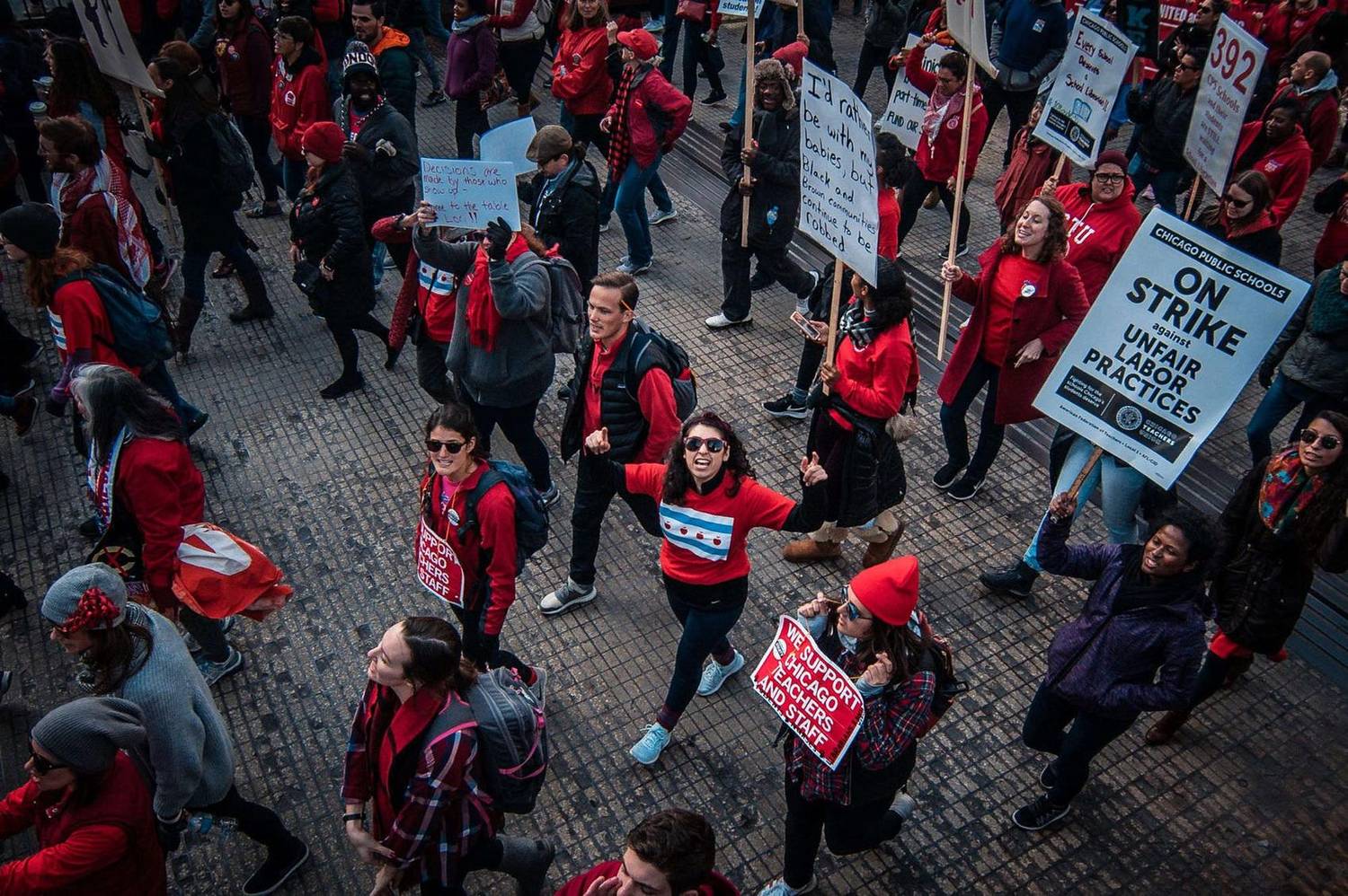 Crowd marching with picket signs during a teachers' strike