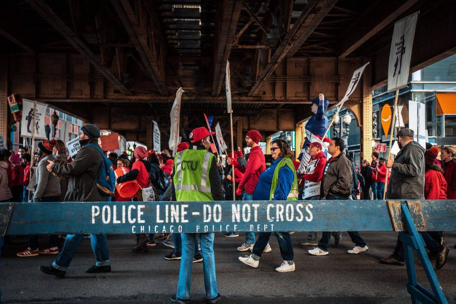 Marchers passing a police barricade during a city strike march