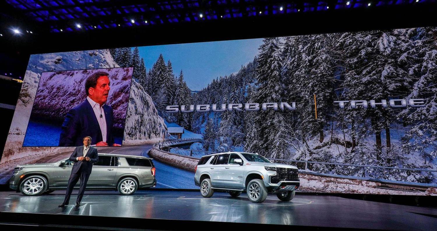 Executive presenting new SUVs on stage during a product reveal