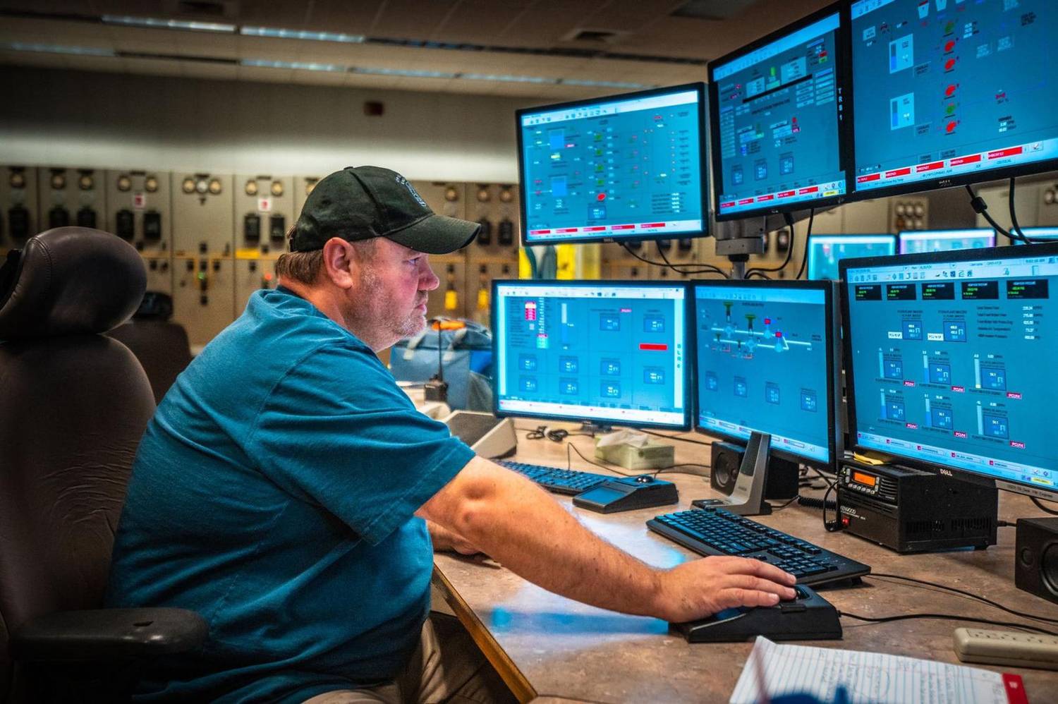 Power plant operator monitoring control room displays