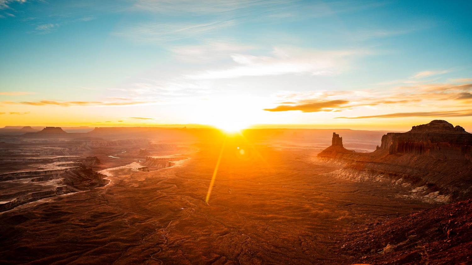 Desert canyon landscape lit by a setting sun