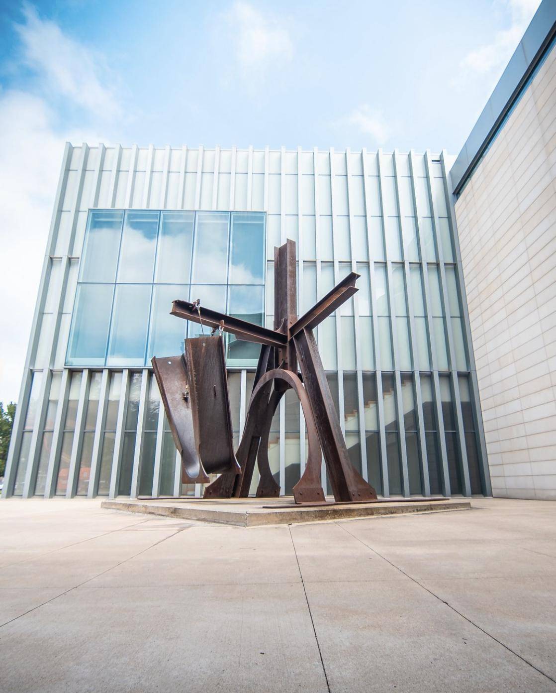 Modern museum building with a large steel sculpture out front